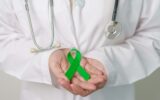 Doctor with green Ribbon for world Mental Health Day