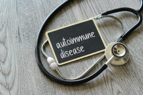 Stethoscope and chalkboard with text AUTOIMMUNE DISEASE