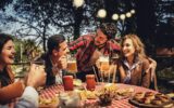 A group of close-knit friends have fun together eating and drinking