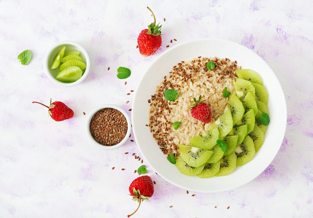 Tasty and healthy oatmeal porridge with kiwi and flax seeds.